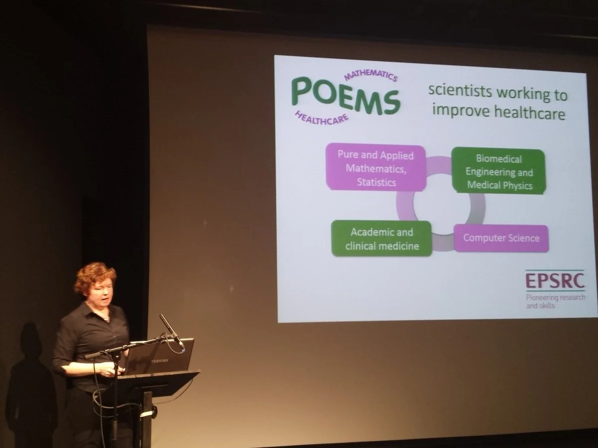 A speaker presenting research on science and healthcare at a lectern