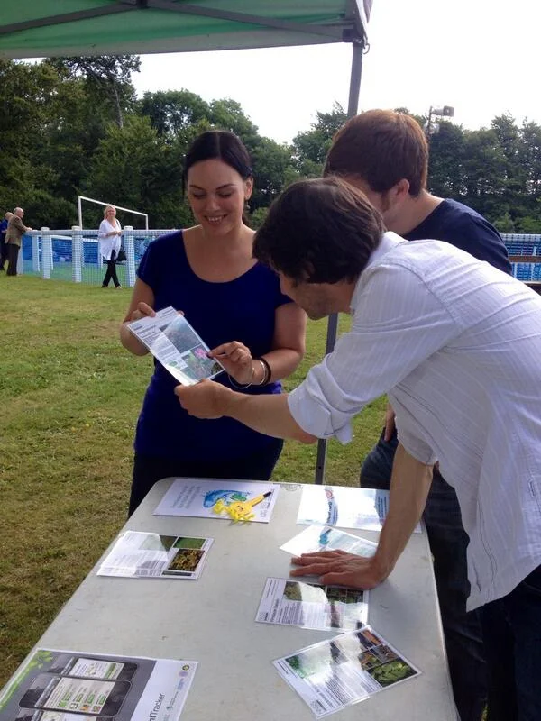 Visitors examining information at an outdoor science display